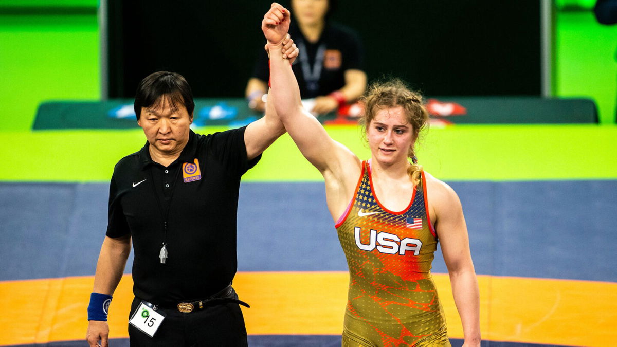 Amit Elor's arm is raised by a referee