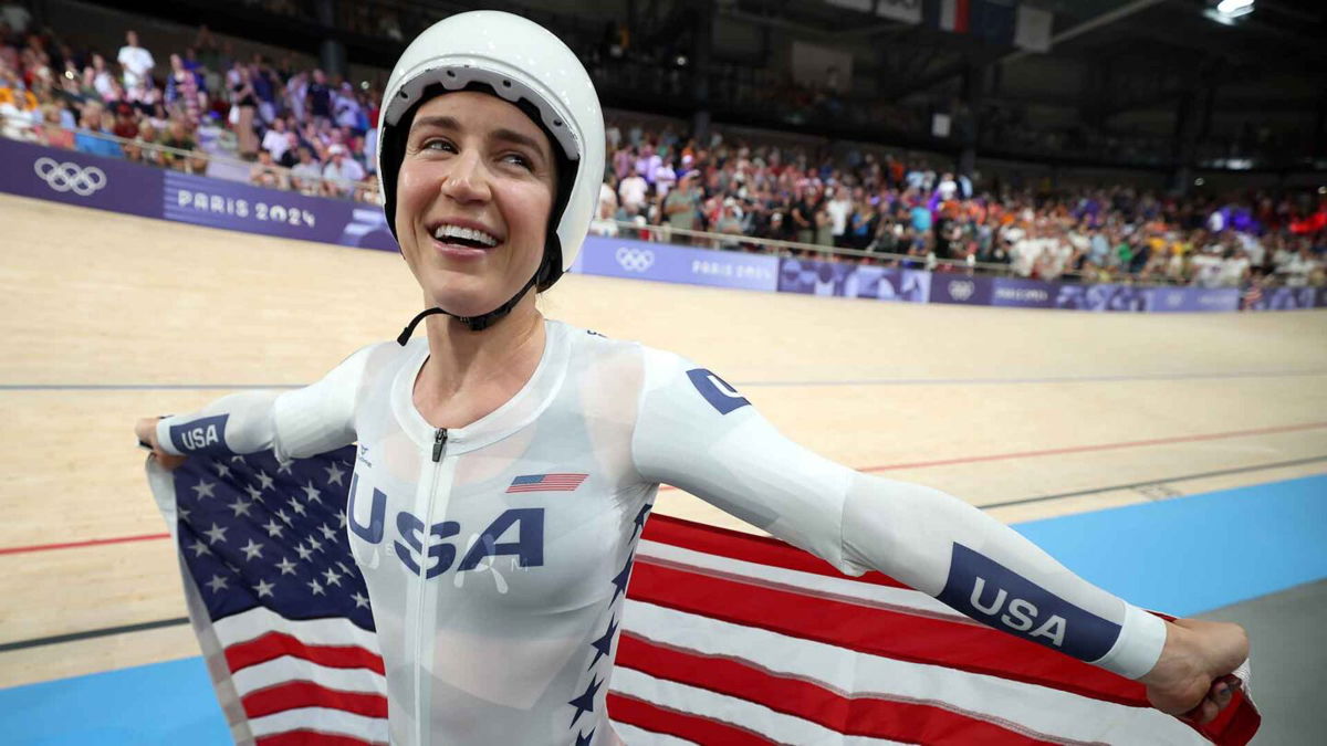 Kristen Faulkner celebrates winning gold in the women's team pursuit.