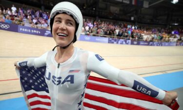 Kristen Faulkner celebrates winning gold in the women's team pursuit.