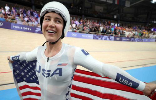 Kristen Faulkner celebrates winning gold in the women's team pursuit.