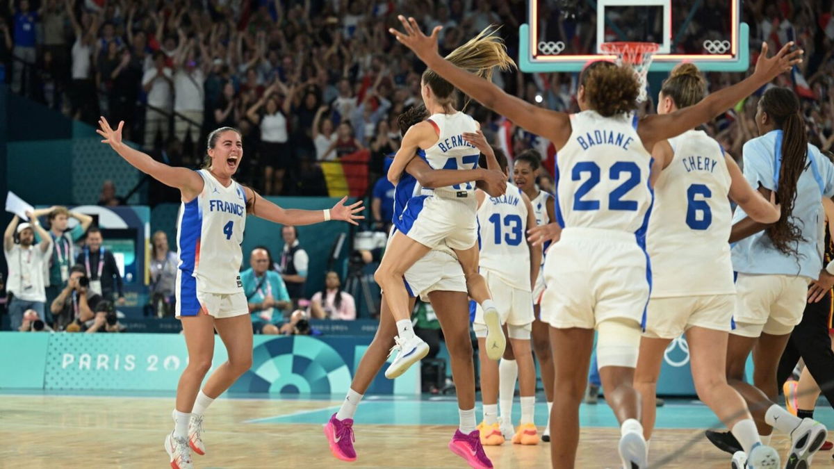 The France women's team celebrates on court after win vs. Belgium