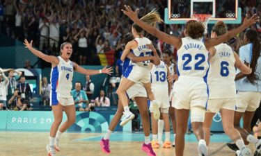 The France women's team celebrates on court after win vs. Belgium