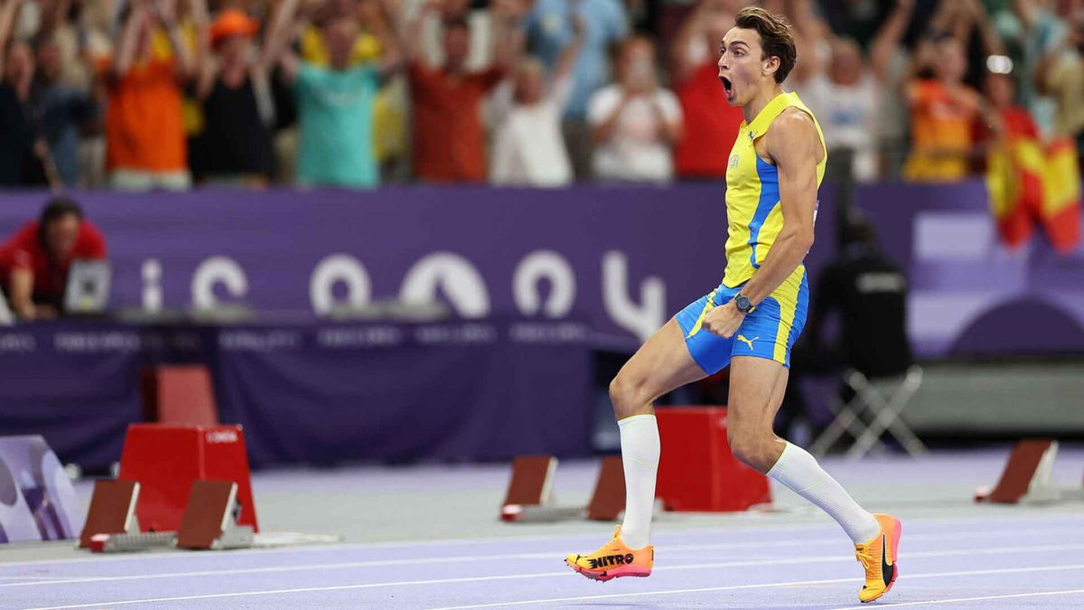 Gold medalist Mondo Duplantis of Sweden celebrates after setting a new world record during the men's pole vault at the 2024 Paris Olympics.