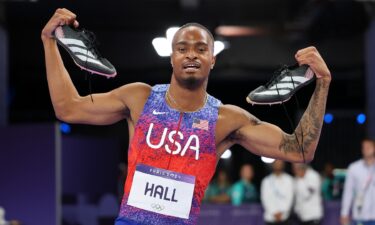 Quincy Hall celebrates by holding up his shoes