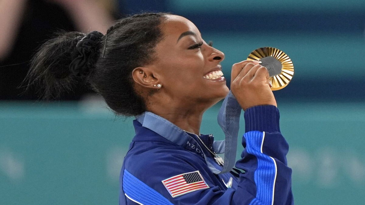 Simone Biles celebrates winning a gold medal at Paris Games