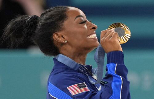 Simone Biles celebrates winning a gold medal at Paris Games