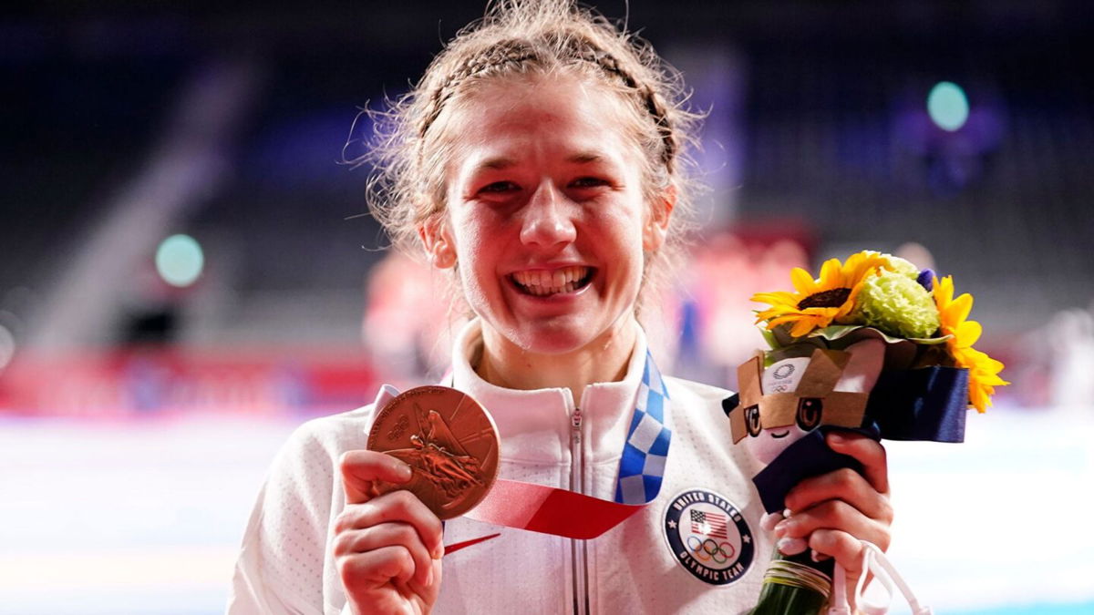 Sarah Hildebrandt holds up her Olympic bronze medal