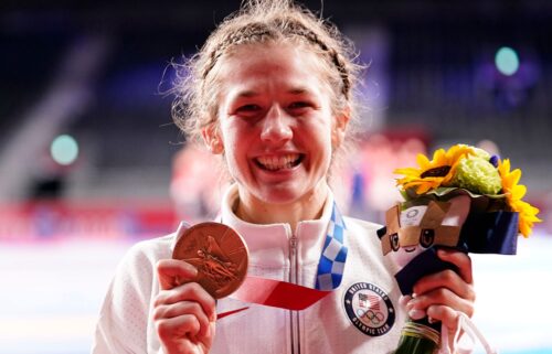 Sarah Hildebrandt holds up her Olympic bronze medal