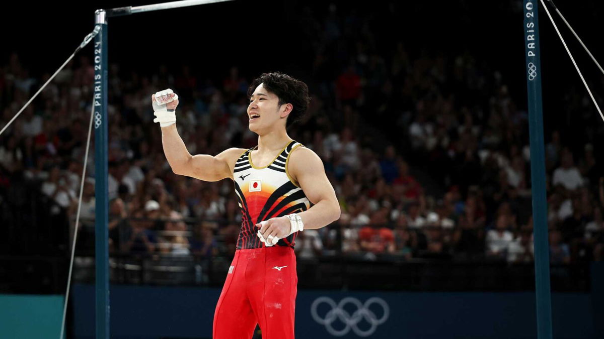 Shinnosuke Oka of Team Japan pumps his fist in the air after competing in the high bar final at the 2024 Paris Olympics.