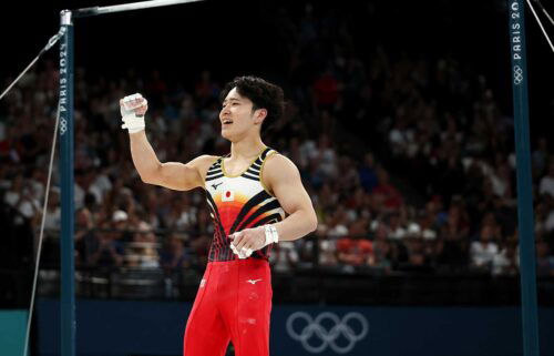 Shinnosuke Oka of Team Japan pumps his fist in the air after competing in the high bar final at the 2024 Paris Olympics.