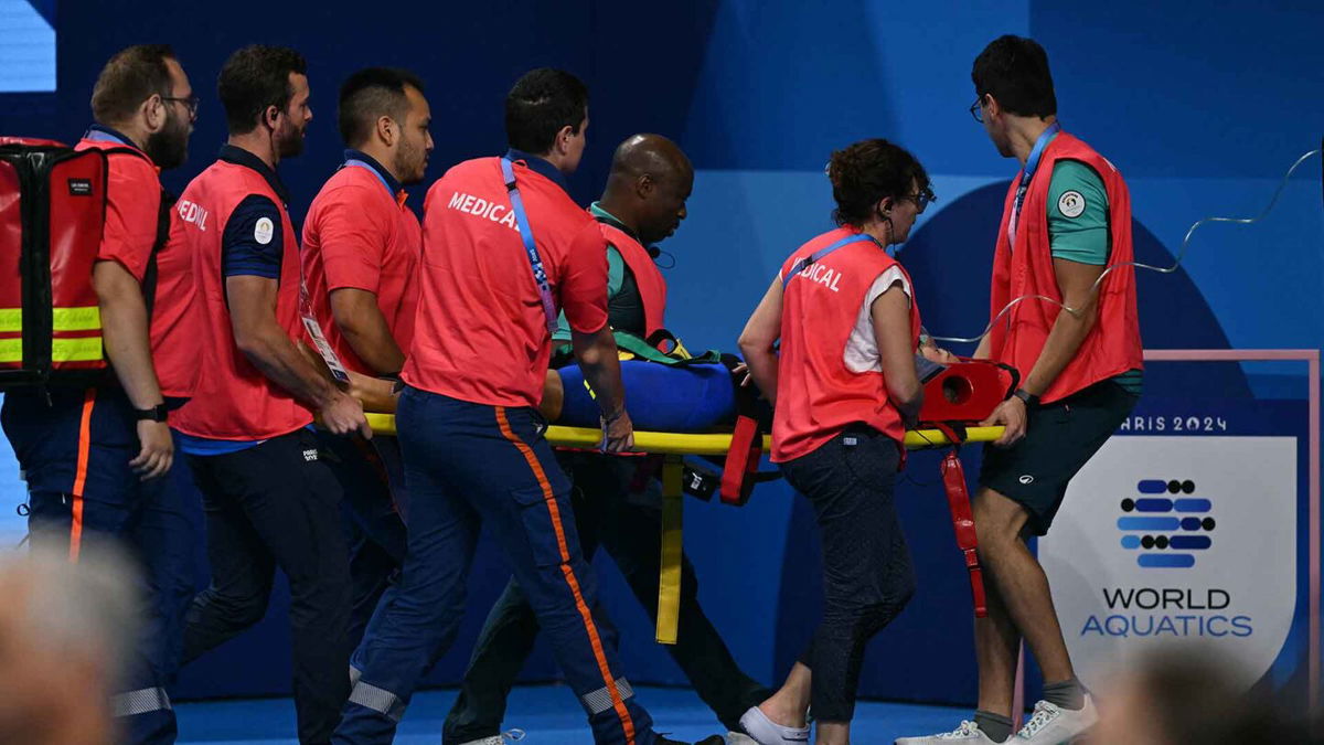 Medical staff carry Slovakia's Tamara Potocka on a stretcher after she collapsed following a heat of the women's 200m individual medley swimming event during the 2024 Paris Olympic Games