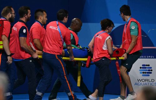 Medical staff carry Slovakia's Tamara Potocka on a stretcher after she collapsed following a heat of the women's 200m individual medley swimming event during the 2024 Paris Olympic Games