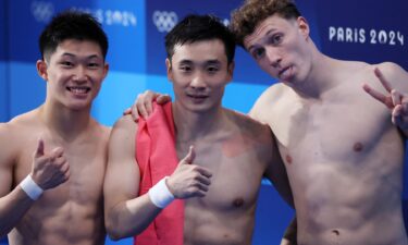 Cao Yuan poses alongside Rikuto Tamai and Noah Williams after the men's 10m platform final.