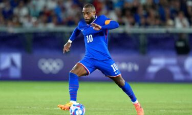 Alexandre Lacazette dribbles with the ball.