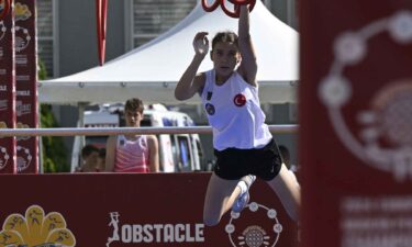 An athlete competes in the new obstacle course in the modern pentathlon.