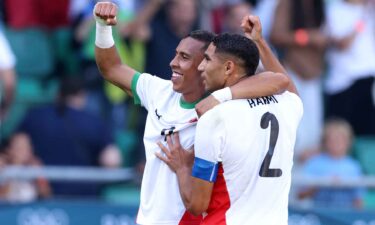 Morocco players celebrate after scoring goal.