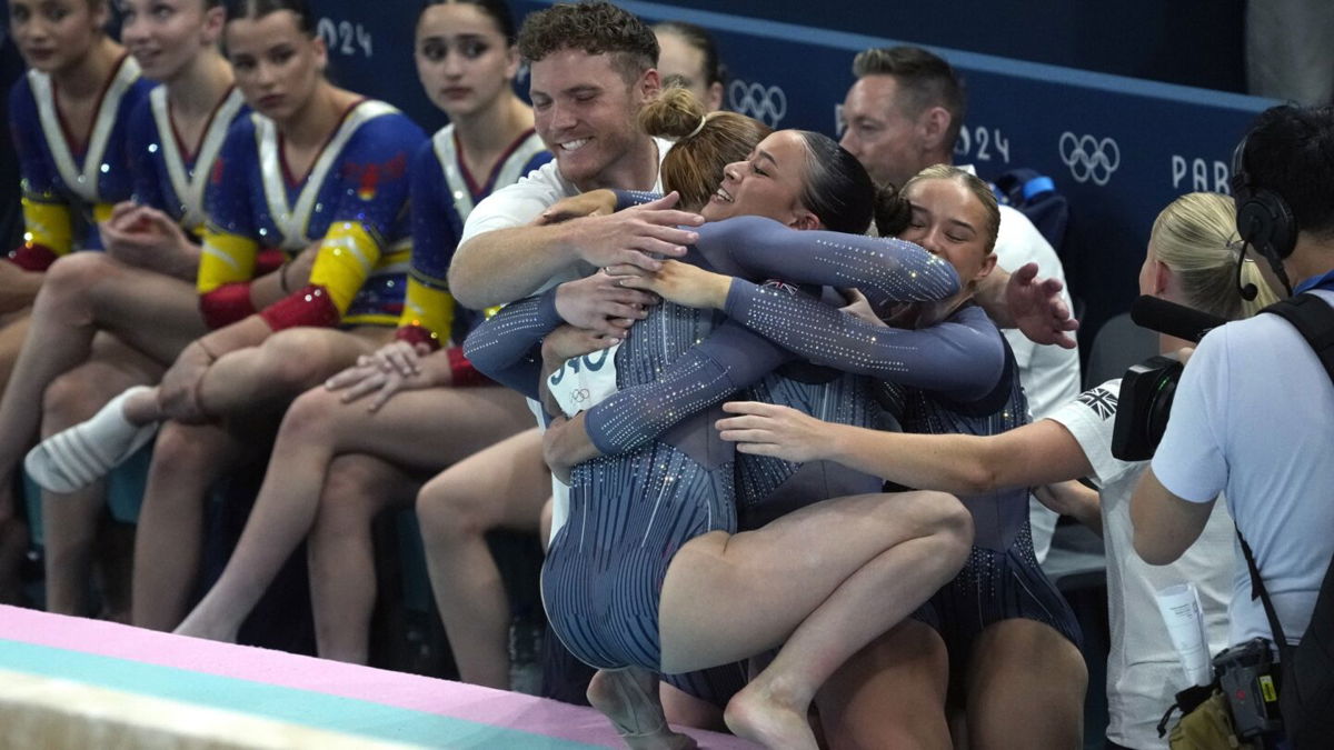 Members of the Great Britain women's gymnastics team hug during the team final at the 2024 Paris Olympics.