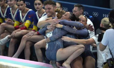 Members of the Great Britain women's gymnastics team hug during the team final at the 2024 Paris Olympics.