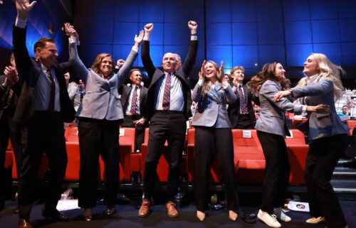 Members of the Utah 2034 delegation celebrate as Salt Lake City
