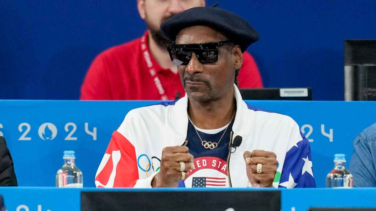 Snoop Dogg watches an event at the Olympics