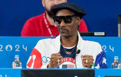 Snoop Dogg watches an event at the Olympics