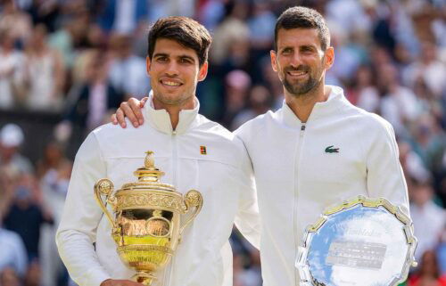 Carlos Alcaraz of Spain and Novak Djokovic of Serbia pose with their trophies after the men’s singles final on day 14 at All England Lawn Tennis and Croquet Club.