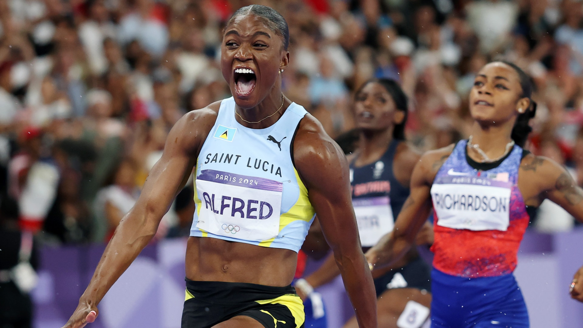 Julien Alfred of Saint Lucia crosses the finish line during the women's 100m final at Stade de France.