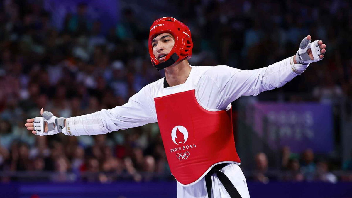 Arian Salimi of Team Islamic Republic of Iran celebrates winning the Men's +80kg Gold Medal at Grand Palais on August 10