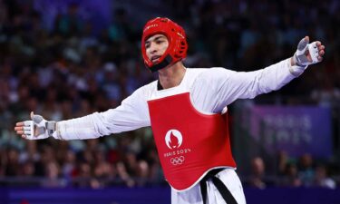 Arian Salimi of Team Islamic Republic of Iran celebrates winning the Men's +80kg Gold Medal at Grand Palais on August 10