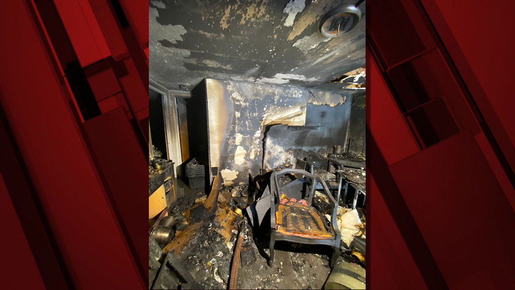 Fire caused by candle left burning heavily damaged NE Bend home's basement early Wednesday; smoke alarm awakened resident, who escaped with 2 dogs, called 911.