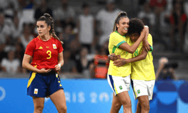 Priscila and Vitoria Yaya celebrate yellow-clad Brazil's second goal against Spain.