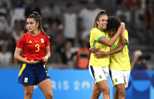 Priscila and Vitoria Yaya celebrate yellow-clad Brazil's second goal against Spain.