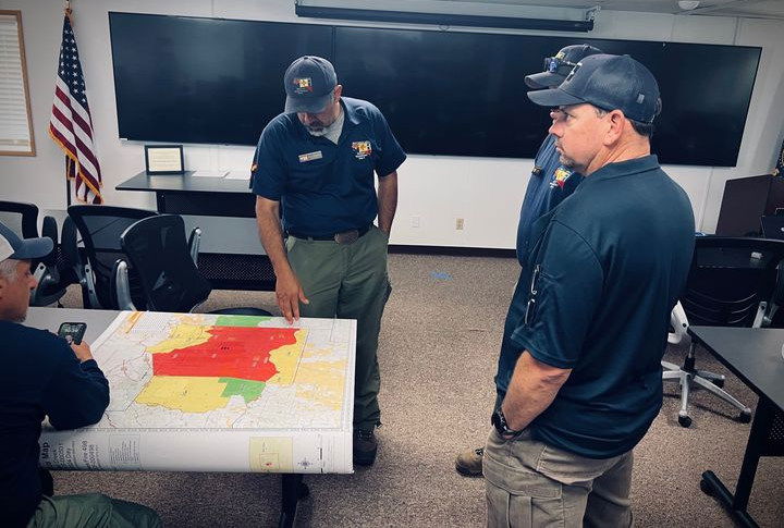 Fire managers discuss tactics to rein in the 75,000-acre Crazy Creek Fire.