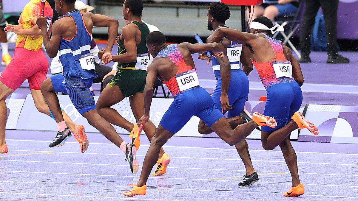 Christian Coleman attempts to pass baton to Kenny Bednarek