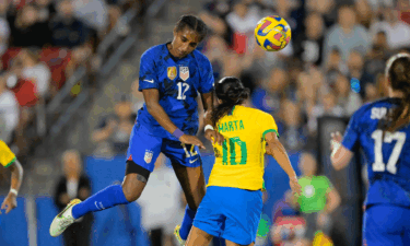 Naomi Girma of the USWNT heads a ball over Marta of Brazil