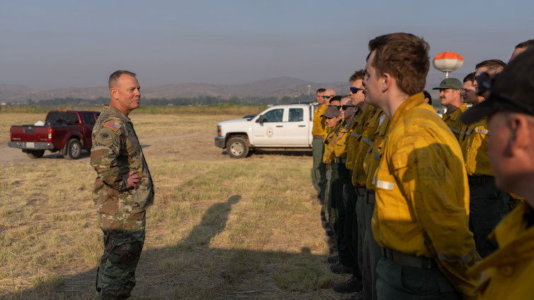 Brig. Gen. Alan Gronewold, the Adjutant General of Oregon, speaks with a hand crew of Oregon Air National Guard members before their movement to the Telephone Fire on Aug. 6,  at the Harney County Fairgrounds fire camp. 