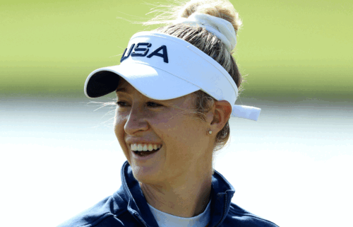 Nelly Korda smiles underneath a white visor at Day 1 of women's golf at the 2024 Paris Olympics