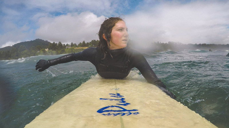 Maia Insinga paddles her surfboard off the Oregon coast. 