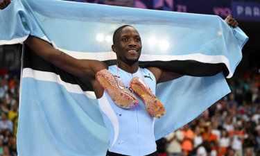 Botswana's Letsile Tebogo crosses the finish line ahead of Kenny Bednarek and Noah Lyles to win the men's 200m final at the Paris Olympics.