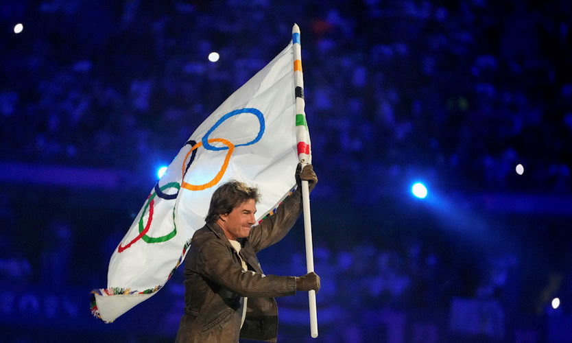 Tom Cruise carries the Olympic flag during the 2024 Summer Olympics closing ceremony at the Stade de France, Sunday, Aug. 11, 2024, in Saint-Denis, France.