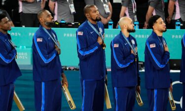 U.S. men's basketball team looks at U.S. flag during anthem at medal ceremony