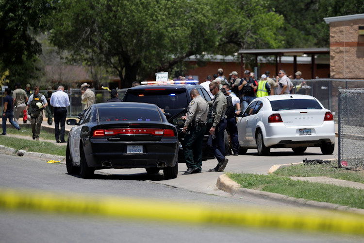 Law enforcement officers guard the scene of a shooting at Robb Elementary School in Uvalde, Texas, on May 24, 2022.