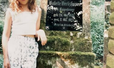 American Erin Levi stands next to the grave of her grandfather's grandmother