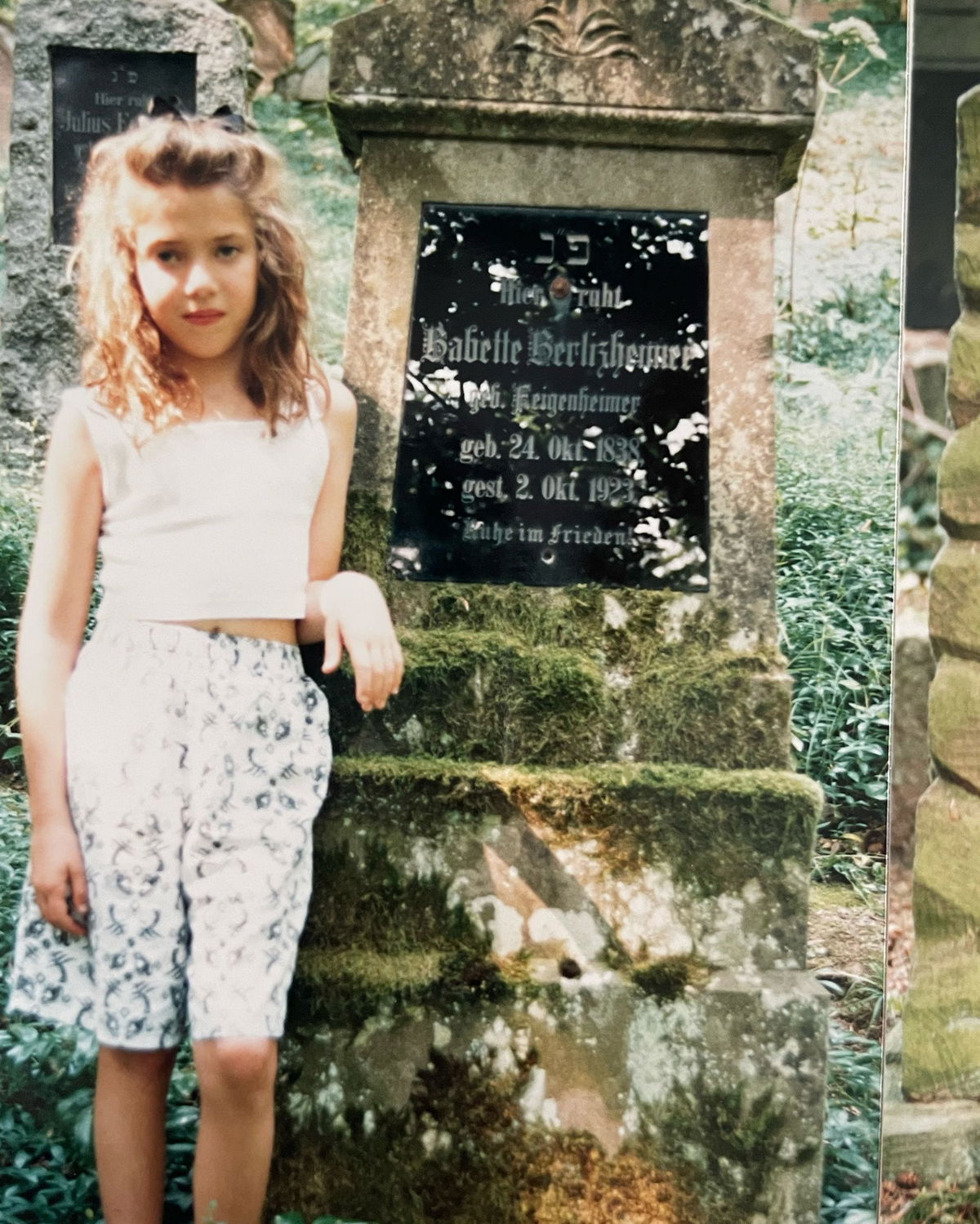 <i>Courtesy Erin and Bruce Levi/Levi Family Archive via CNN Newsource</i><br/>American Erin Levi stands next to the grave of her grandfather's grandmother