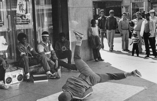 A crowd gathers to watch a youth breakdancing on a piece of linoleum in 1980 in New York City's Times Square.