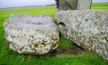 The Altar Stone can be seen underneath two bigger Sarsen stones.