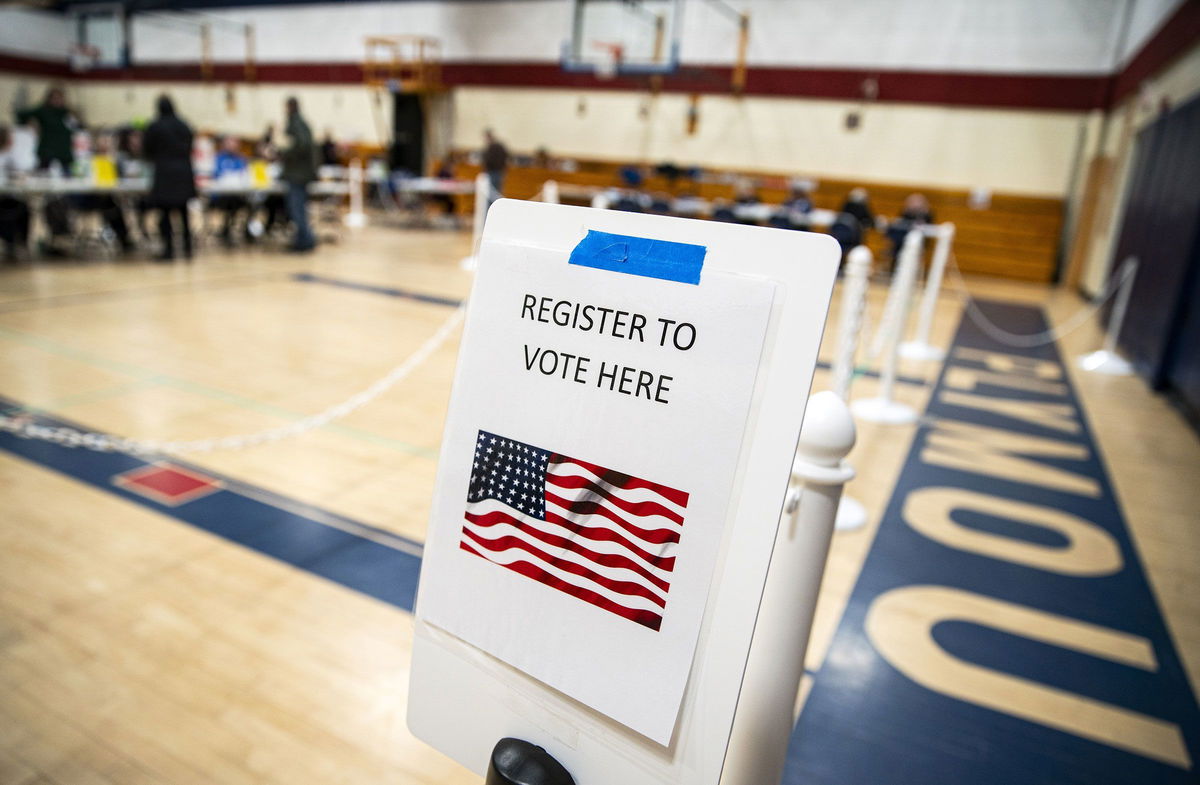 <i>Al Drago/Bloomberg/Getty Images via CNN Newsource</i><br/>A sign to register to vote at a polling station inside Plymouth Elementary School in Plymouth