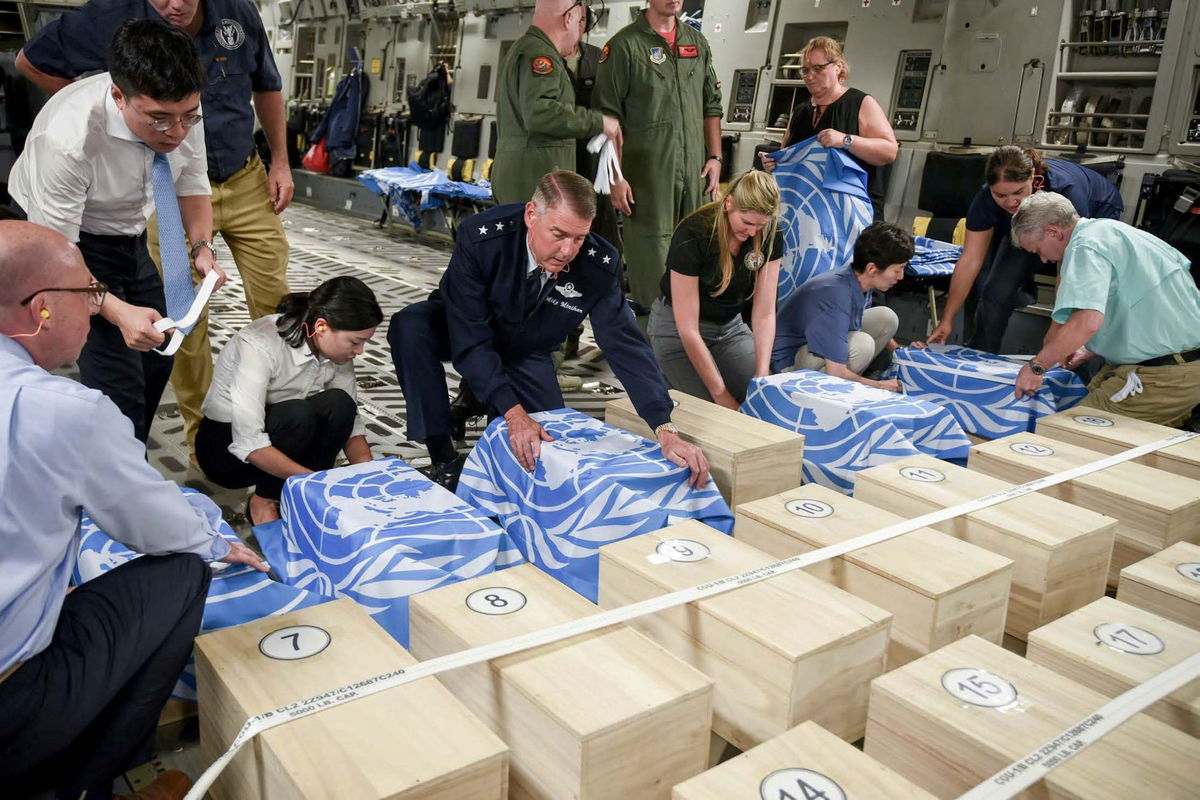 <i>US Forces Korea/Reuters/File via CNN Newsource</i><br/>Crew and officials from the United Nations Command and U.S. Defense POW/MIA Accounting Agency (DPAA) secure UNC flags over transit cases of remains thought to be of U.S. soldiers killed in the 1950-53 Korean War