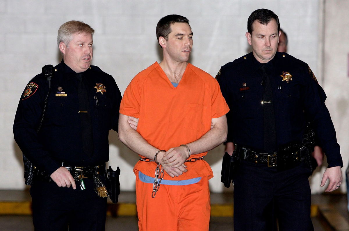 <i>Justin Sullivan/Getty Images via CNN Newsource</i><br/>Convicted murderer Scott Peterson is escorted by two San Mateo County deputies as he is walked from the jail to an awaiting van March 17