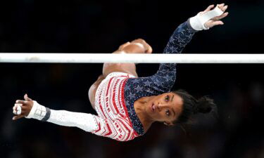 Simone Biles competes on the uneven bars in the women's team final at the Paris Olympics.